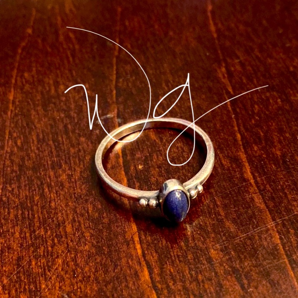 Retired James Avery Ring with a beautiful purple oval lapis stone in the center.